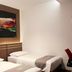 Neotel Hotel City Centre in Tanjung Redeb: twin beds with wall art in a guest room