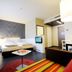 harry's home Dornbirn hotel & apartments guest room with bed, sofa, desk and seating area