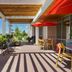 Home2 Suites by Hilton Idaho Falls patio with outdoor seating, red umbrellas, and pergola shade