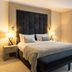 La Réserve Resort in Knokke Heist guest room with king bed, bench, and sitting area by the window