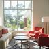 Hilton Garden Inn Tampa-East/Brandon lobby seating area with large windows and red chairs