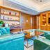Hulunbeier Hotel in Hulunbuir lounge with teal seating, wood paneling, and built-in TV cabinet