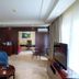 Bintumani hotel room in Freetown with seating area, TV, desk, and large window with curtains