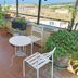 Il Camaleonte dal 2005 in Bracciano: terrace with potted plants, table and chairs, countryside view