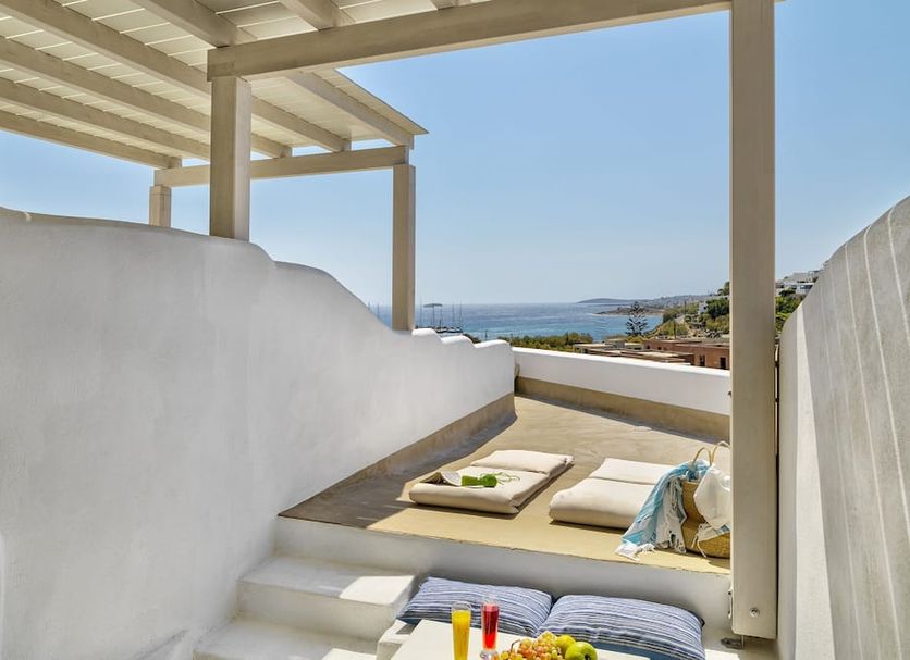 Aloni Hotel & Suites in Parikia terrace lounge with sea view, cushions, and pergola shade