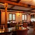The Wiremill in Lingfield restaurant interior with wooden beams, tables, chairs and staircase