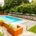 Sweet Hotel in Schiavon outdoor swimming pool with lounge chairs, umbrellas, and landscaped planters