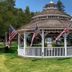 Amber's Inn & Suites in Wisconsin Dells featuring a gazebo with American flags on a green lawn