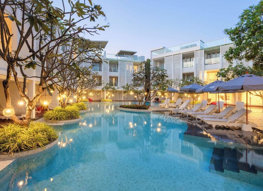 The Sea Cret Hua Hin in Hua Hin featuring a tranquil outdoor pool with lounge chairs and umbrellas