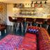 Lairds Lodge Inverness lounge with leather seating, wood stove and bar area in Inverness