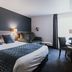 Sure Hotel by Best Western Limoges Sud in Feytiat: guest room with king bed, desk and seating area