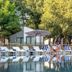Forest Village Resort in Medjugorje with outdoor pool, sun loungers, umbrellas and trees