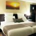 C Hotel Tiberias guest room with double bed, bedside lamps and wardrobe in Tiberias