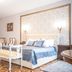 Safrano Palace in Braşov: elegant room with ornate bed, patterned floor, chandelier and vintage chairs