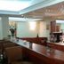 C Hotel Tiberias bar with long counter, stools, glassware, and backlit shelves in Tiberias