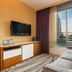 Hilton Club West 57th Street New York guest room with sofa, TV, and city view through large windows