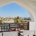 Juweira Boutique Hotel, Salalah: arched balcony with sea view and palm-lined resort below