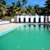 Calangute Residency in Calangute, with an outdoor pool, palm trees, and sun loungers