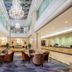 Haili Garden Hotel Guangzhou lobby with chandeliers, seating area, and polished marble floors