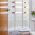 AYZ Javier Cabrini in Madrid bathroom with sink, toilet, frosted glass shower, and tiled wall