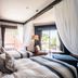 The Beach Terrace Hotel Ao Ishigaki room with two beds, sheer drapes and balcony view in Ishigaki