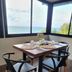 Sea Garden Resort Haad Chao Phao dining table by ocean-view windows in Ko Pha Ngan