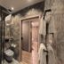 Hotel Aquarius Dubrovnik bathroom with walk-in shower, wall-mounted toilet, and doorway to bedroom in Dubrovnik