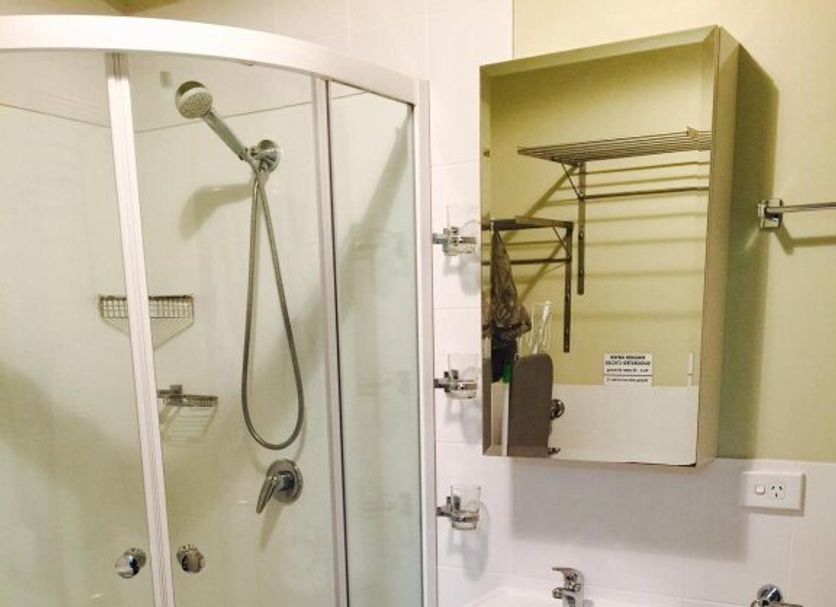 Westside Studio Apartments in Armidale bathroom with shower, sink vanity and toilet