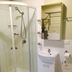 Westside Studio Apartments in Armidale bathroom with shower, sink vanity and toilet