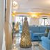 Club Hotel Marina Beach in Orosei: elegant lounge with blue sofas, chandeliers, and decorative lanterns