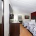 Red Roof Inn Kenly - I-95 guest room with two beds, TV, and red accent wall in Kenly