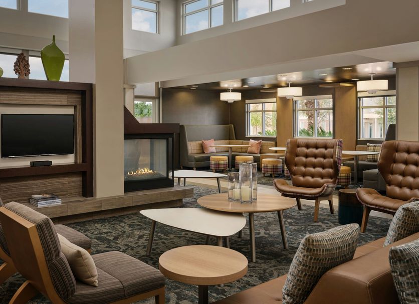 Residence Inn by Marriott Savannah Airport lobby with fireplace, seating area, and large windows in Pooler