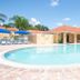 Berkley Lake Townhomes in Kissimmee with a sunny outdoor pool and lounge chairs