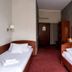 Aneks Kazimierz hotel room in Krakow with two single beds, striped walls and red carpet