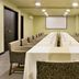 Meeting room at Movich Casa del Alferez in Cali with long conference table and projector screen