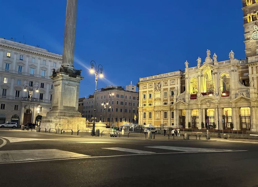 Biancoreroma B&B in Rome with a city square view at dusk and historic buildings