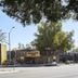 Greentree Pasadena Inn in Pasadena exterior with palm trees and street view