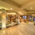 Sinclairs Bayview, Port Blair lobby with lounge seating, wood floors, and large ocean-view windows