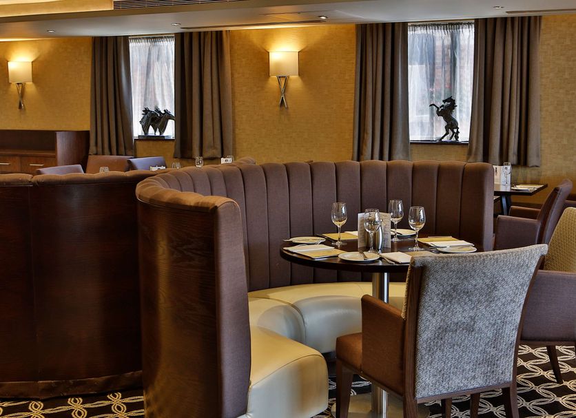 Best Western Heath Court Hotel Newmarket lounge with curved booths and table settings
