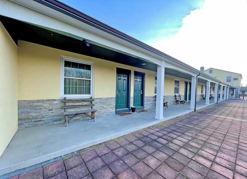 Red Carpet Inn & Suites Morgantown exterior corridor with covered walkway and room entrances