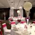 Qubus Hotel Bydgoszcz banquet hall in Bydgoszcz with round tables, white chair covers and pink accents
