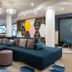 Hampton by Hilton Rome North Fiano Romano lobby with sectional seating and colorful geometric shelving