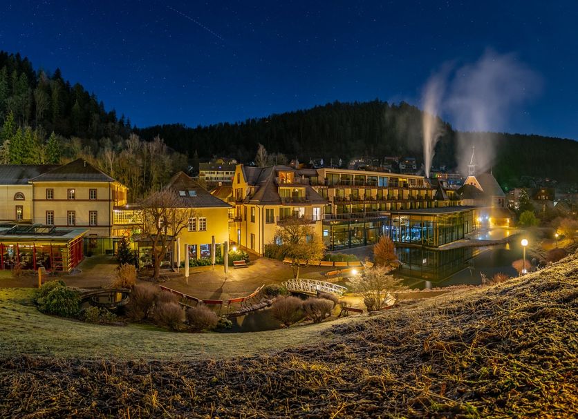 Hotel Therme Bad Teinach in Bad Teinach-Zavelstein at night with glowing spa buildings and steam