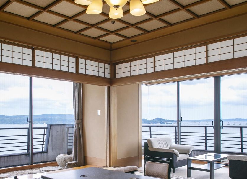 Hotel Biwanso in Nanao ocean-view tatami room with seating and sliding glass doors