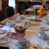 Casa De Casal De Loivos dining table set with white plates, cups, pastries and juice in Casal de Loivos