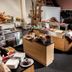 Pension Kreuzjoch, Zell am Ziller: hotel buffet breakfast with pastries, fruit, coffee, and stacked plates