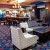 Holiday Inn Express & Suites Huntsville lobby lounge with seating and bar area