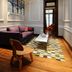 Casa Umare Buenos Aires lounge with stained-glass skylight, purple sofa, wood chair and patterned rug