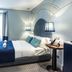 The Lift Boutique Hotel by Ridan Hotels in Lisbon guest room with king bed, blue accents and glass shower