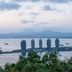 Vienna Hotel Sanya Bay No.1 in Sanya with bay, boats, skyline and mountains at dusk